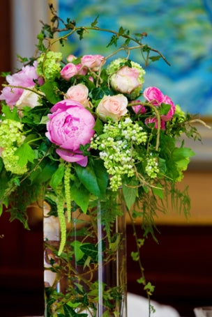 Pink and green flower arrangement in a tall vase