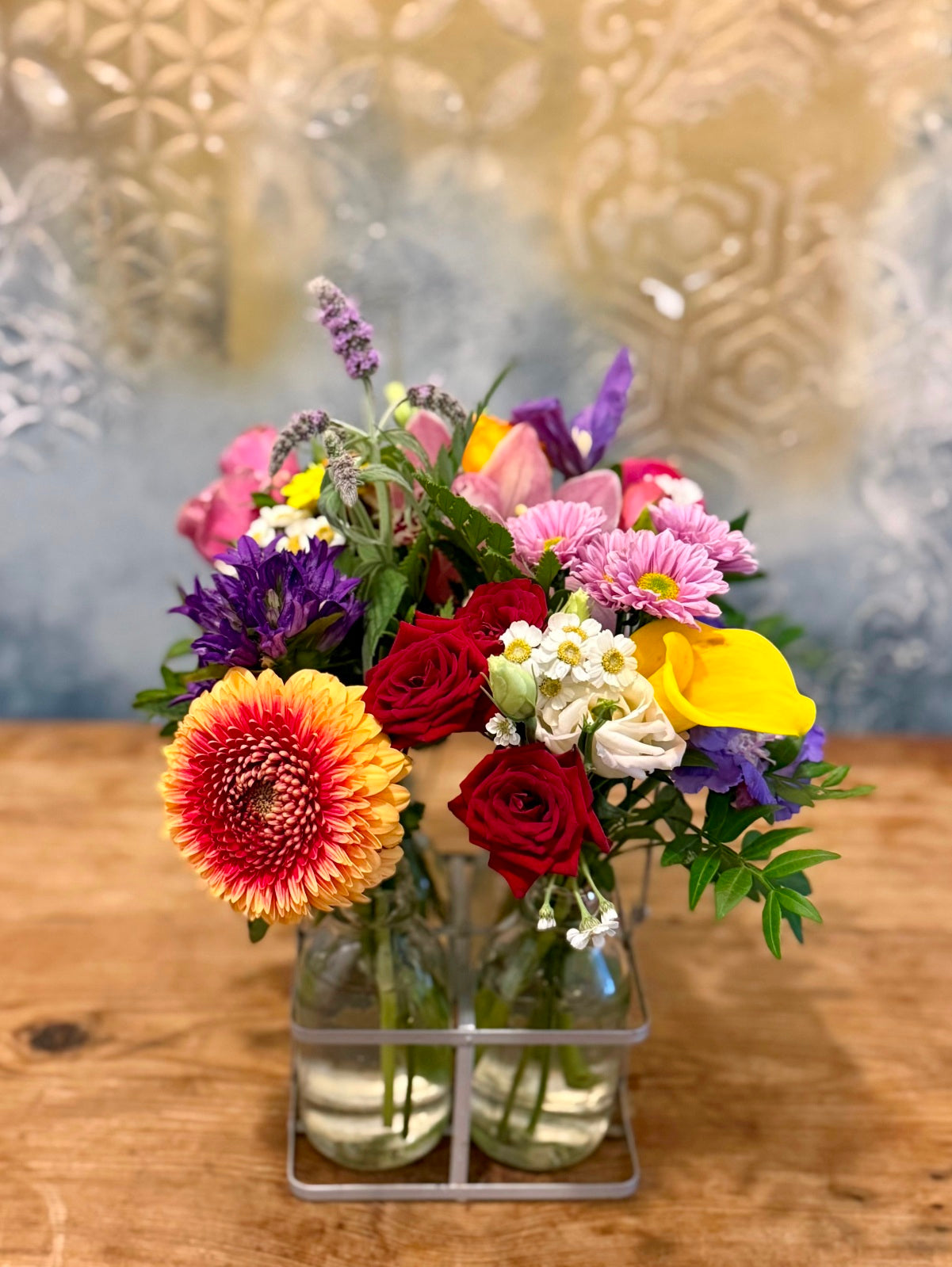 Blooms in Bottles. Petite flower arrangements in two mini milk bottle vases