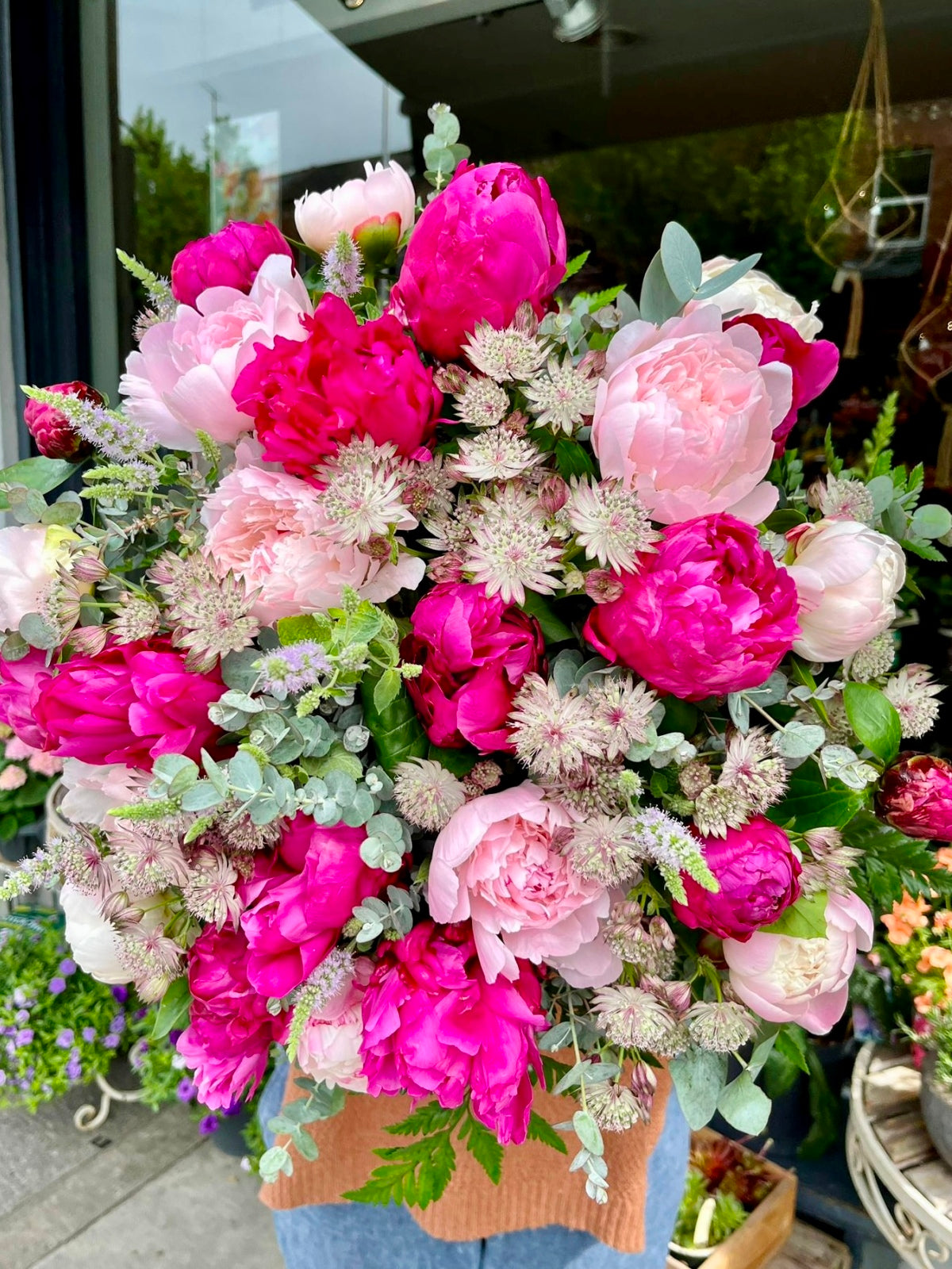 Luxury pink peony flower bouquet being held by a florist