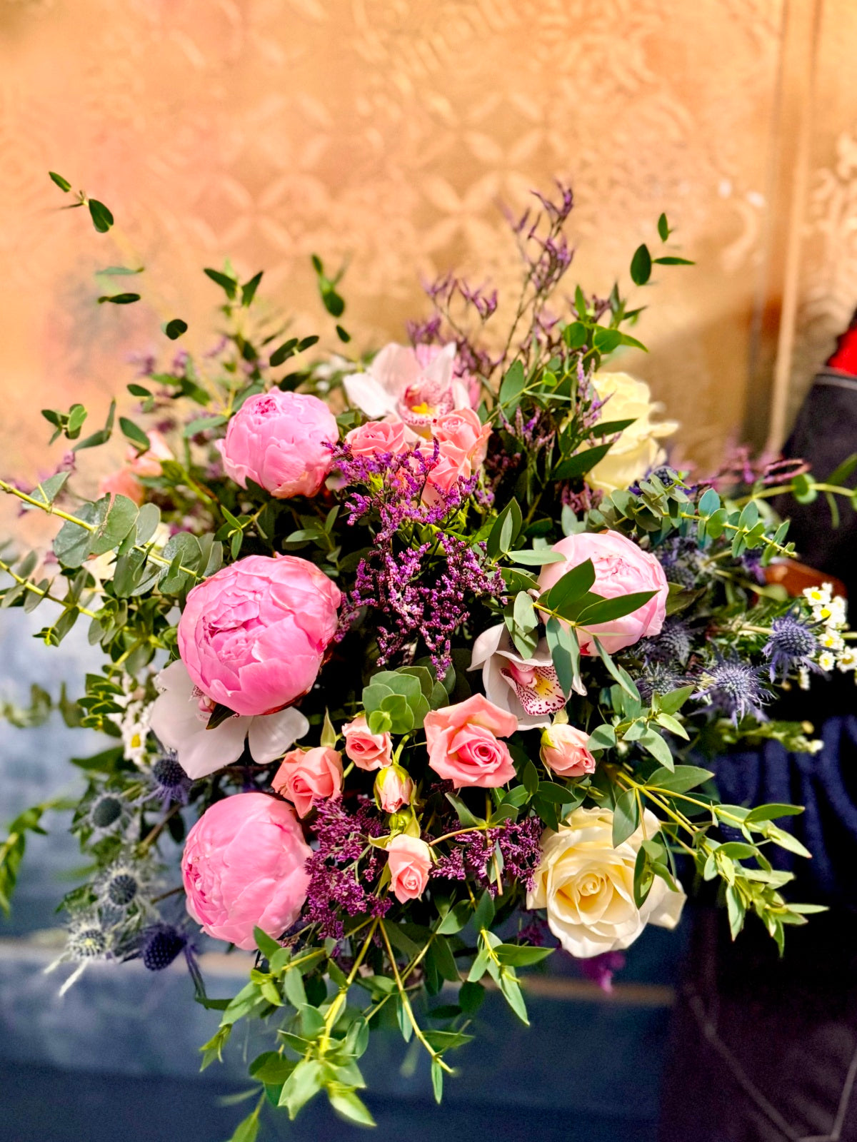 Peony rose flower bouquet being held by a florist
