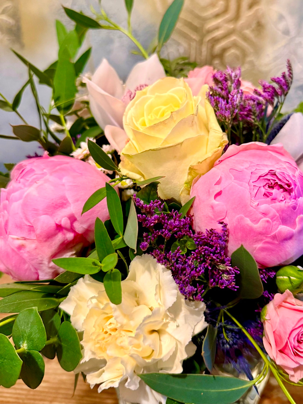 Peony roses flower arrangement in cube vase close up image