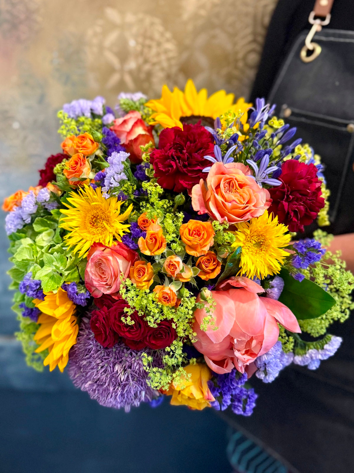 Pride flower bouquet held by a florist