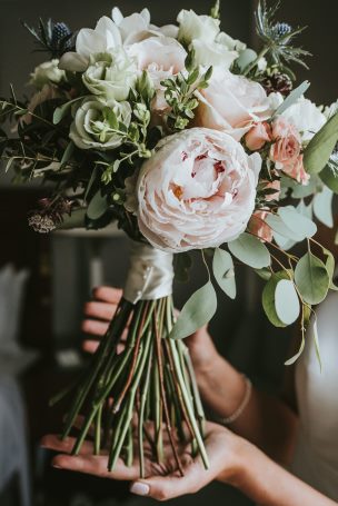 Bridal bouquet in light pink, white and blue peonies