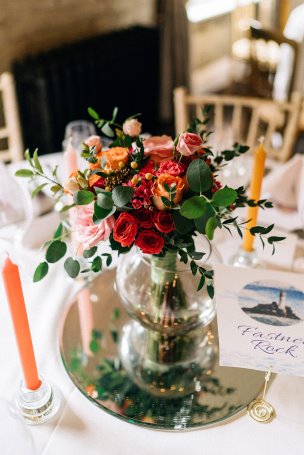 Bridal bouquet in tones of red, orange, pink and green
