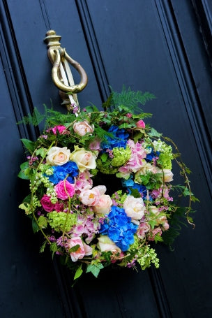 Door wreath in pink, white and blue flowers