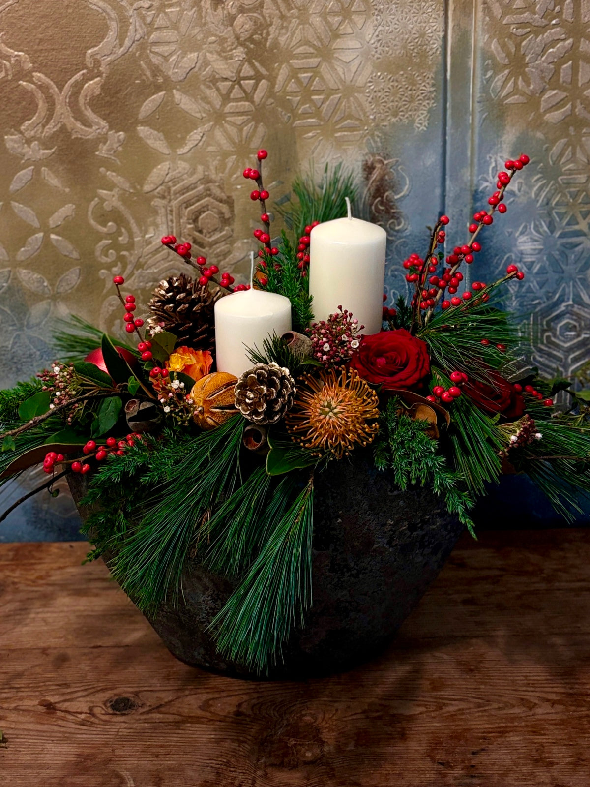 Large Christmas Candle and Red Flower Arrangement in Urn