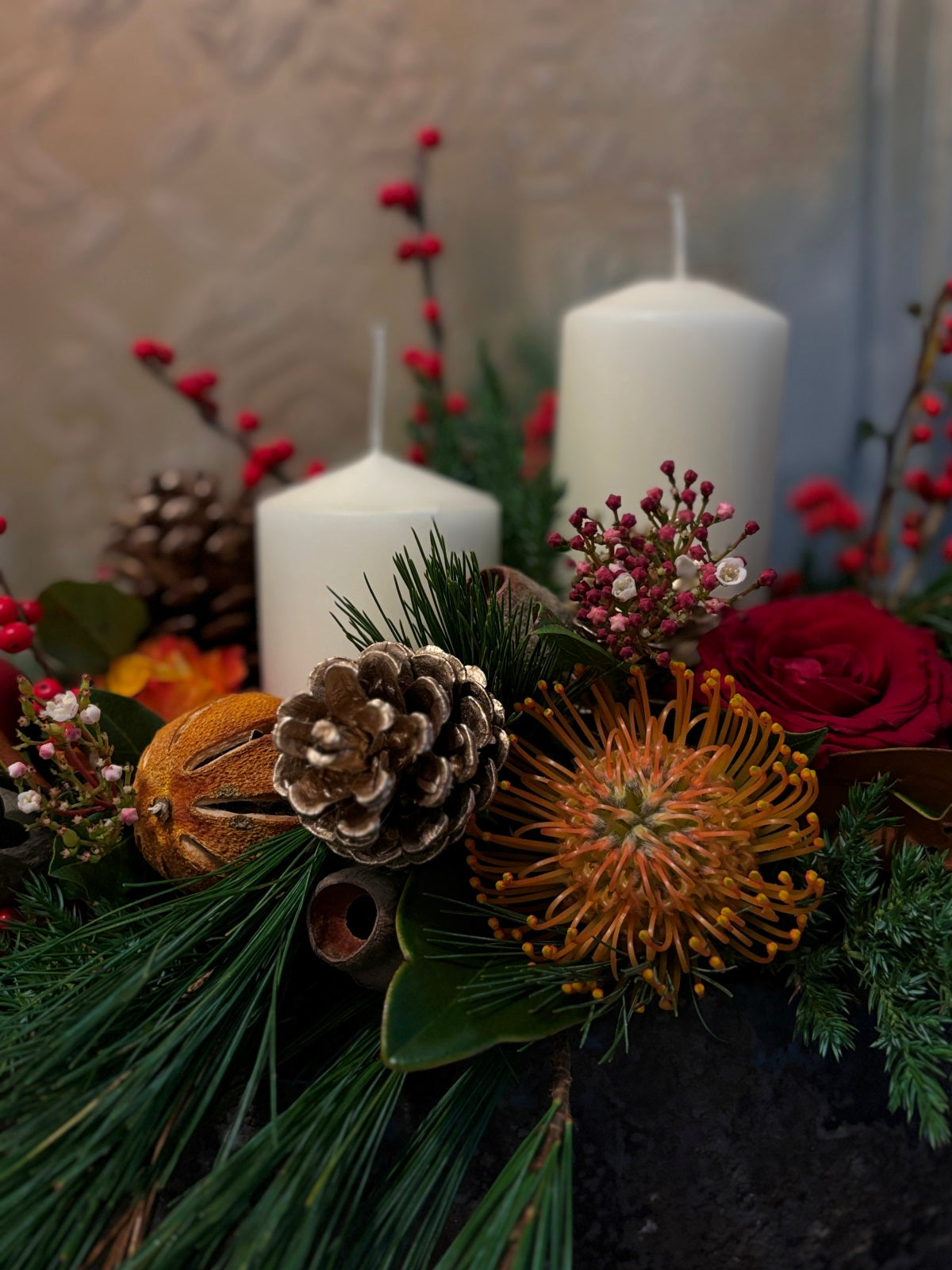 Large Christmas Candle and Red Flower Arrangement in Urn