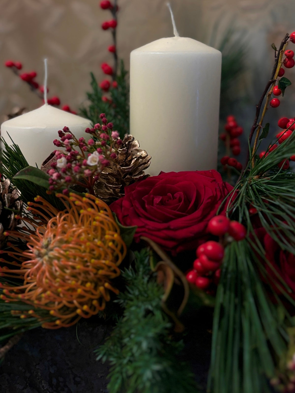 Large Christmas Candle and Red Flower Arrangement in Urn