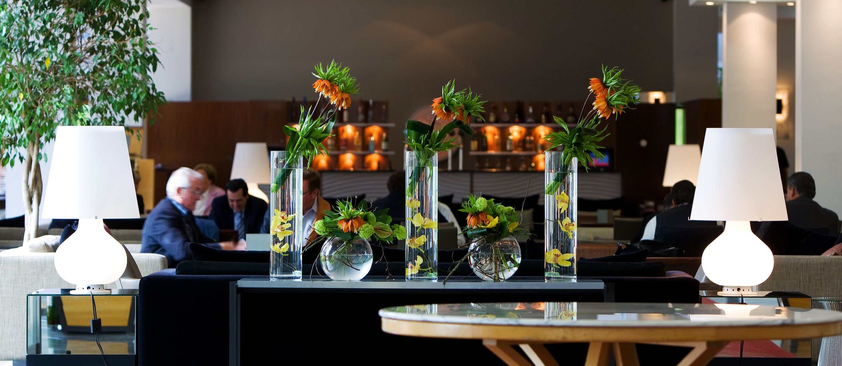 Orange and green flower arrangement in vases