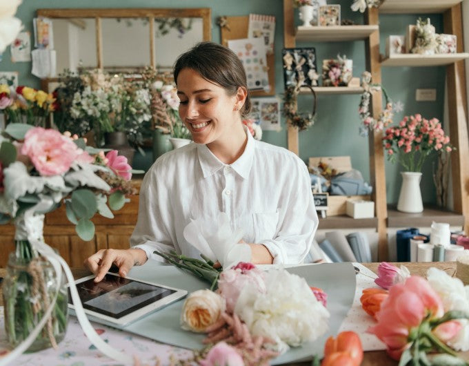 Happy florist in a flower shop