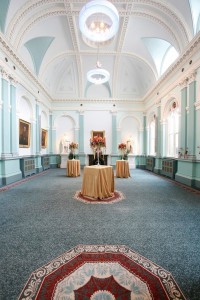 Pod tables with tall flower arrangements in Graves Hall at RCPI 