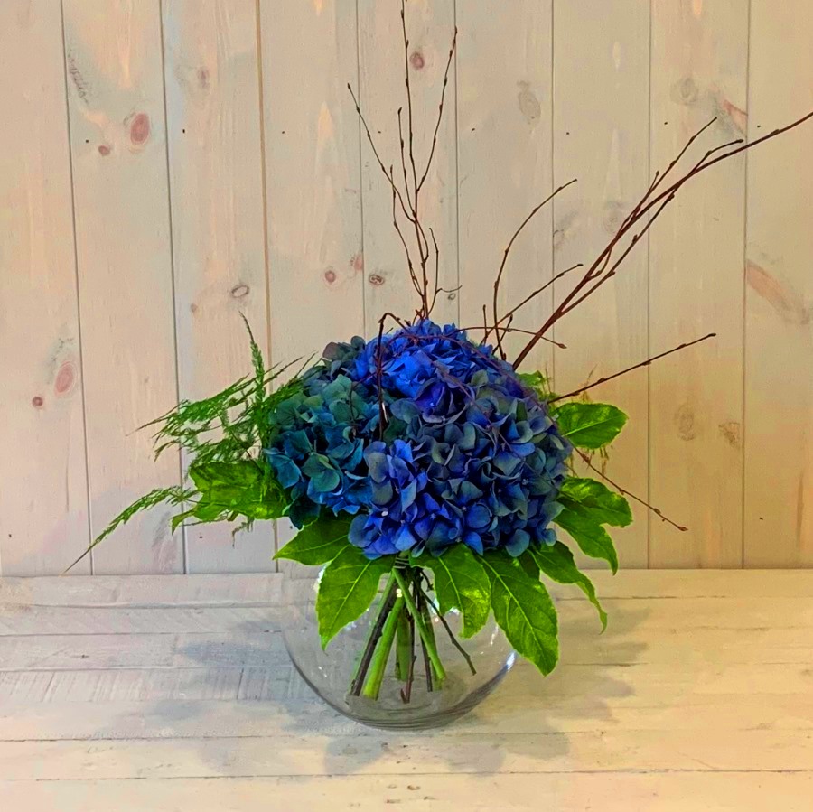 Hydrangea flowers in a clear glass goldfish bowl vase delivered same day in Dublin city and county.n