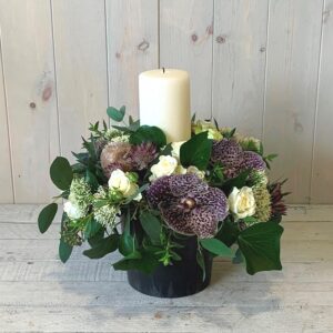 Winter flower arrangement with candle for gift delivery in Dublin. Designed by Blooming Amazing Flower Company.