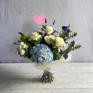 Cream and white flowers for Mothers day with an added touch of blue.