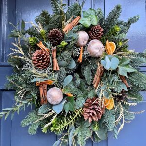 A festive door wreath of cinnamon and pine cones. Designed in Ranelagh and delivered in Dublin for Christmas
