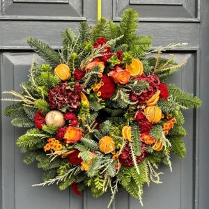 A fresh Christmas door wreath in shades of oranges and lemons. Designed and delivered in Dublin throughout the yuletide season