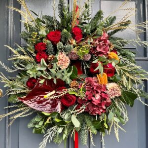 A fresh door wreath in shades of reds celebrating the yuletide season. Available to order to collect and for delivery in Dublin