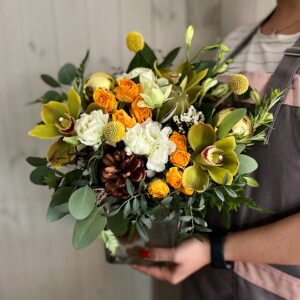 A Christmas themed flower arrangement in whites and oranges in a glass vase. Order online to collect ar choose our gift delivery service in Dublin.