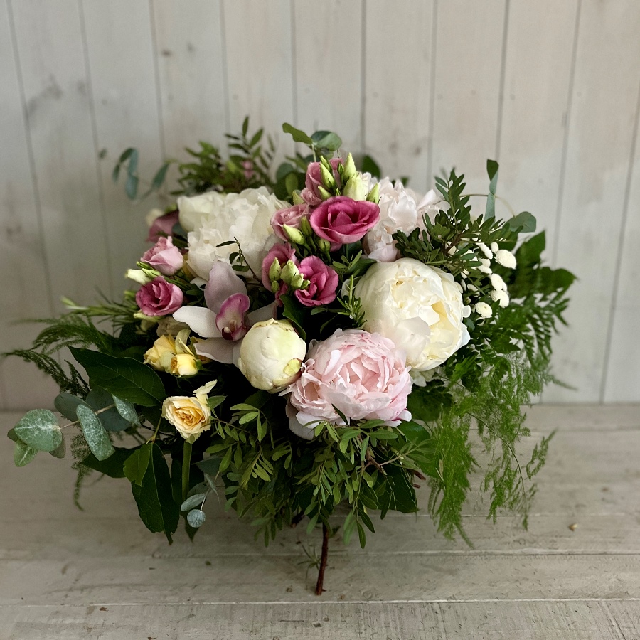 A flower arrangement of Peony roses sent in a cube shaped glass vase available to order to collect or for gift delivery in Dublin