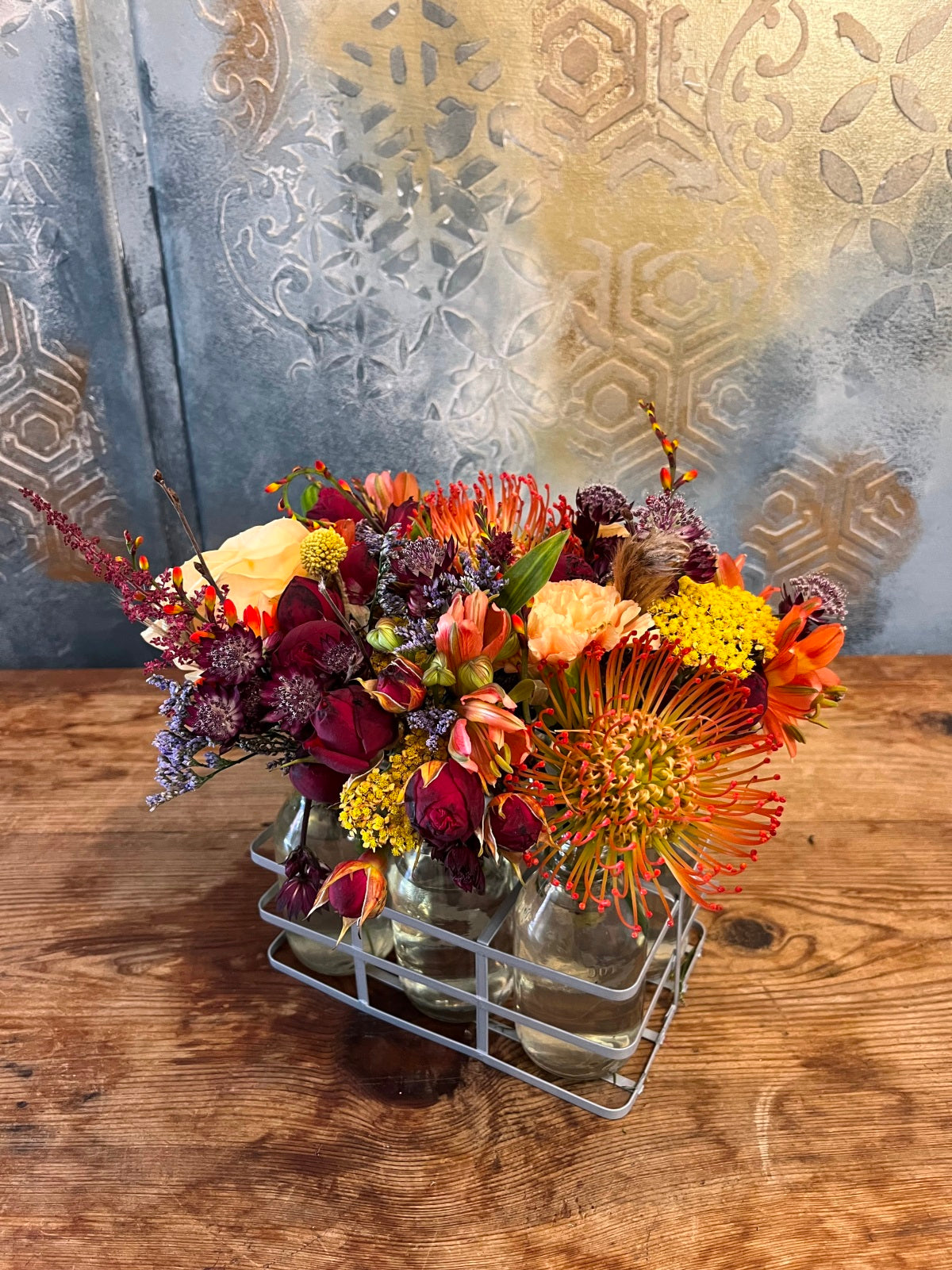 Autumn flowers in mini milk bottle vases