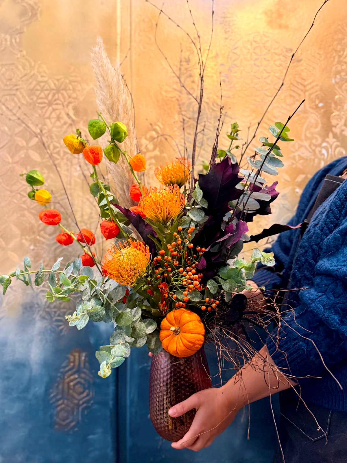 Tall Halloween Flower Bouquet in Vase being held for size reference